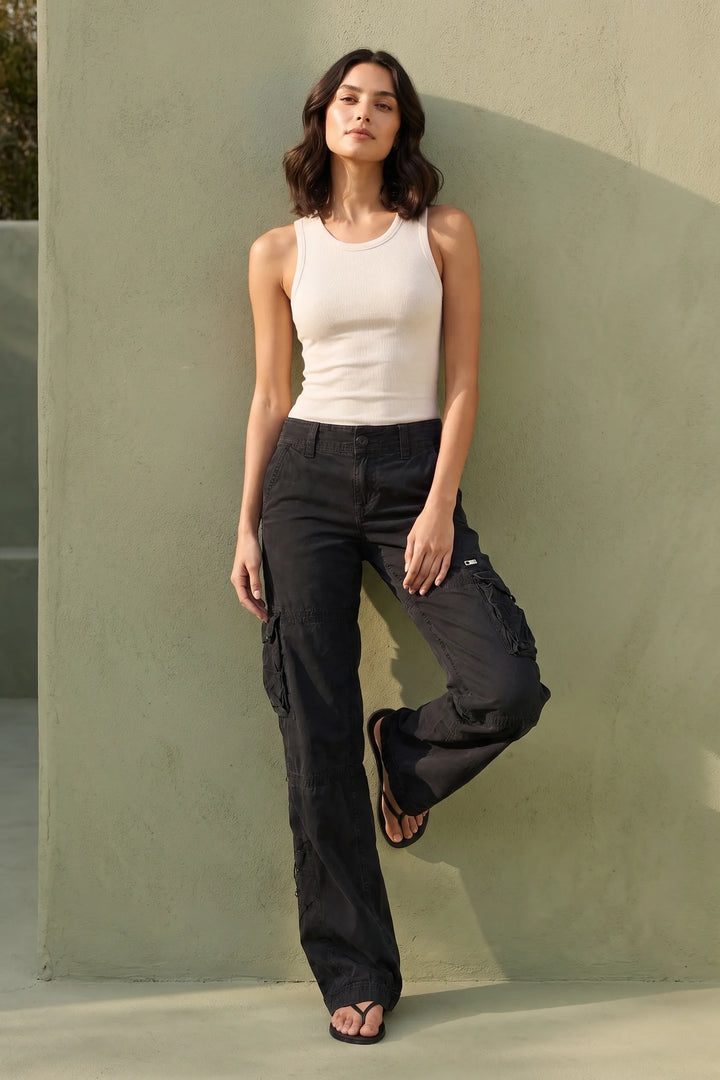 Model wearing black wide-leg cargo pants in a lifestyle setting