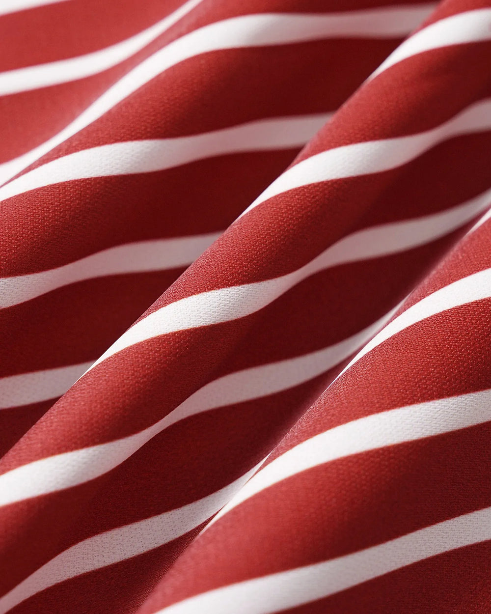 Close-up detail of red striped fabric and puff sleeve construction on a blouse