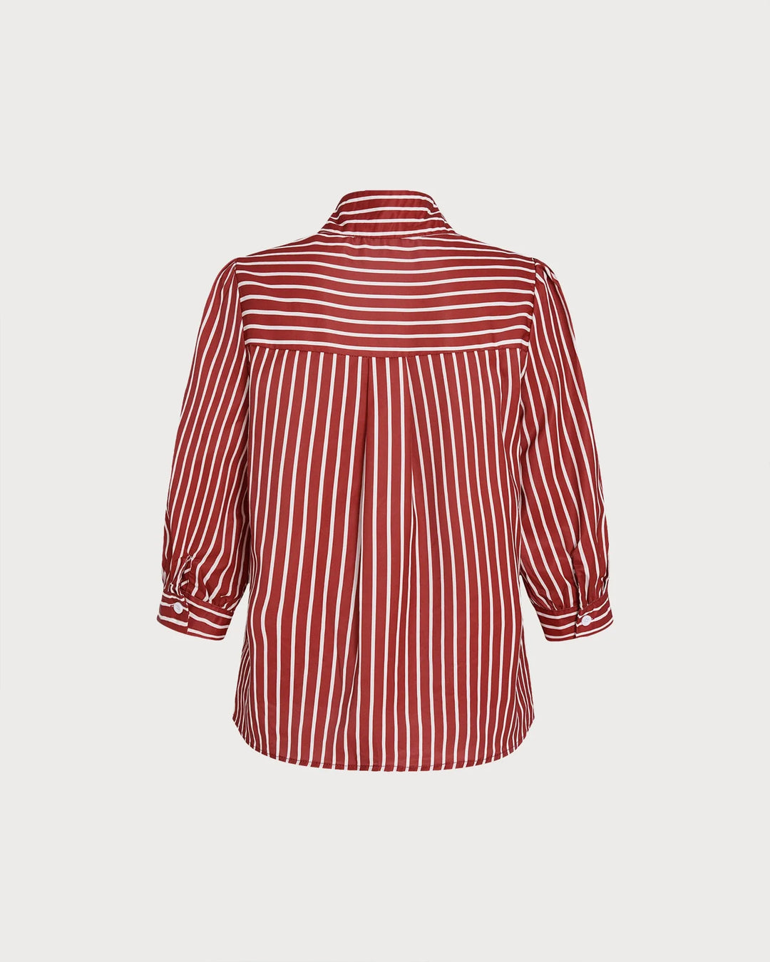 Side view of woman in a red striped blouse with puff sleeves