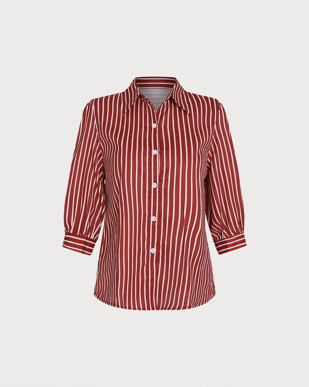Woman in three-quarter turn wearing a red striped puff sleeve blouse