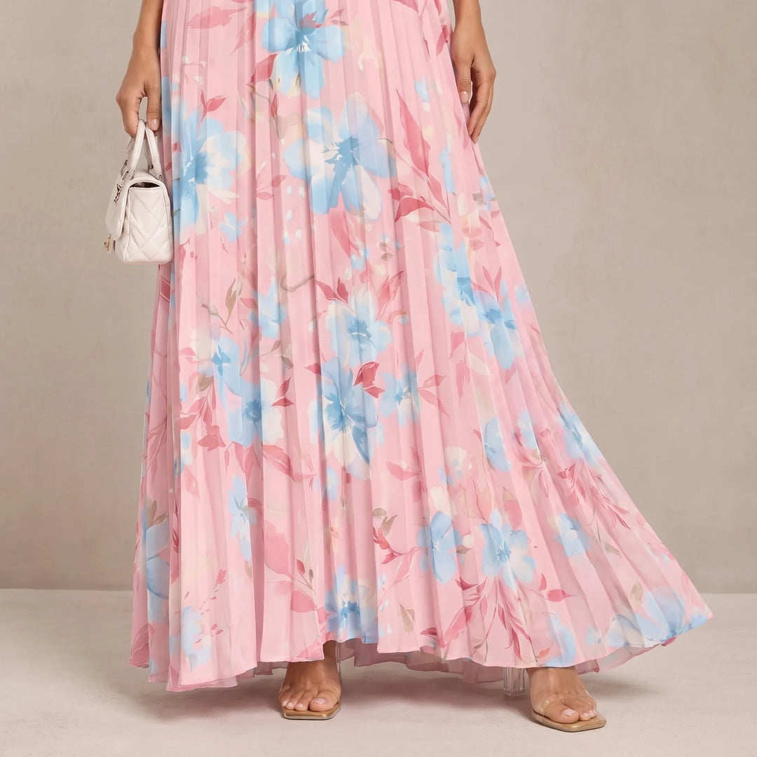 Close-up detail of pink pleated floral maxi dress fabric and construction