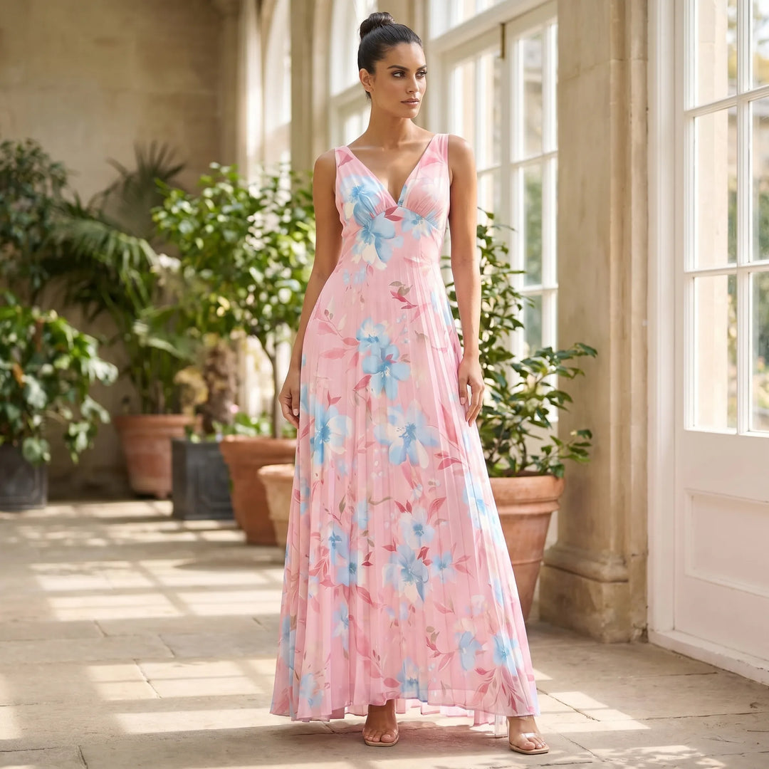 Woman in pink pleated floral maxi dress in an outdoor lifestyle setting