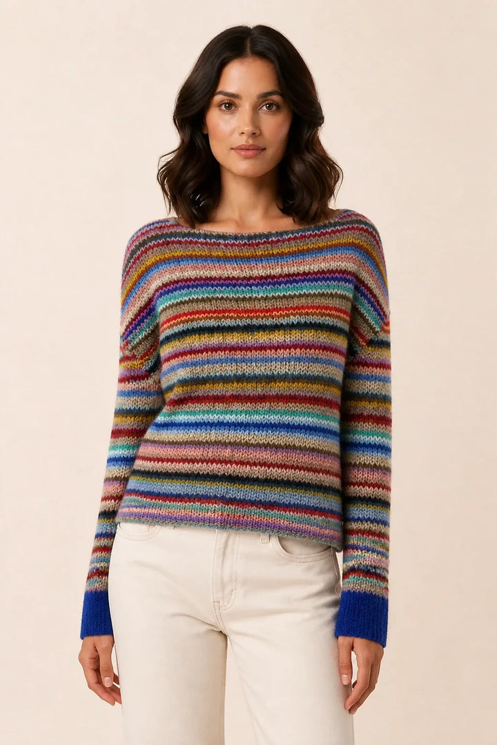 Colorblock stripe sweater in vibrant rainbow tones, model in contrapposto stance