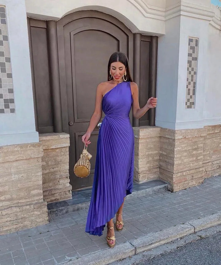Purple pleated one-shoulder midi dress on model facing forward