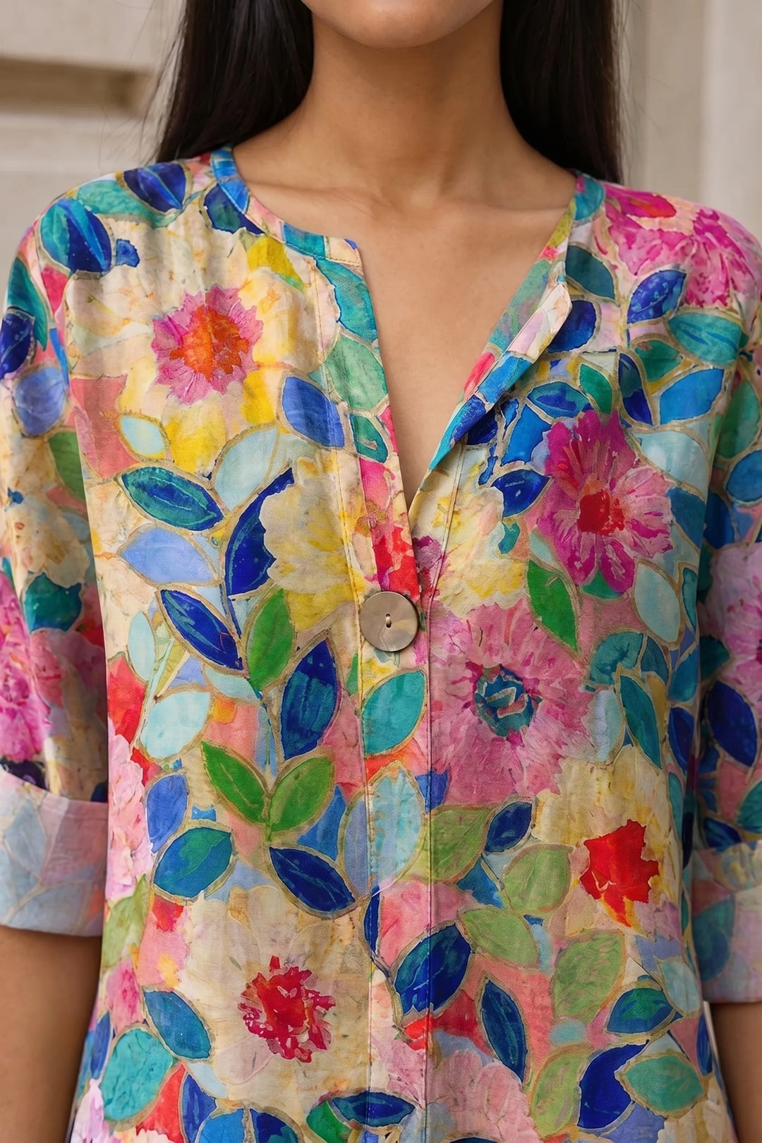 Close-up detail of blue floral print blouse fabric and construction