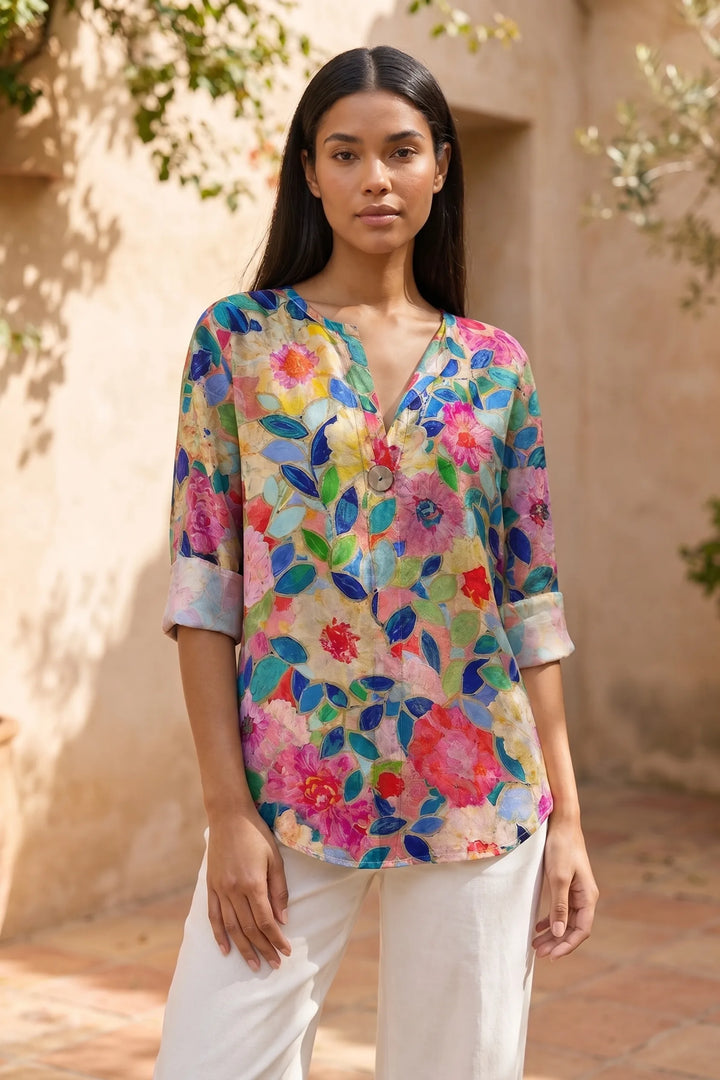 Model wearing blue floral print blouse in lifestyle setting