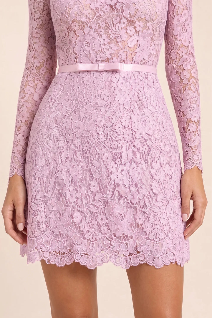 Close-up detail of pink lace fabric and self-tie belt on mini dress