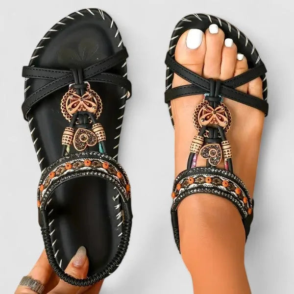 Graphite black beaded flat sandal with boho detailing, three-quarter view
