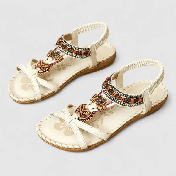 White beaded flat sandal with delicate boho straps and flat open sole