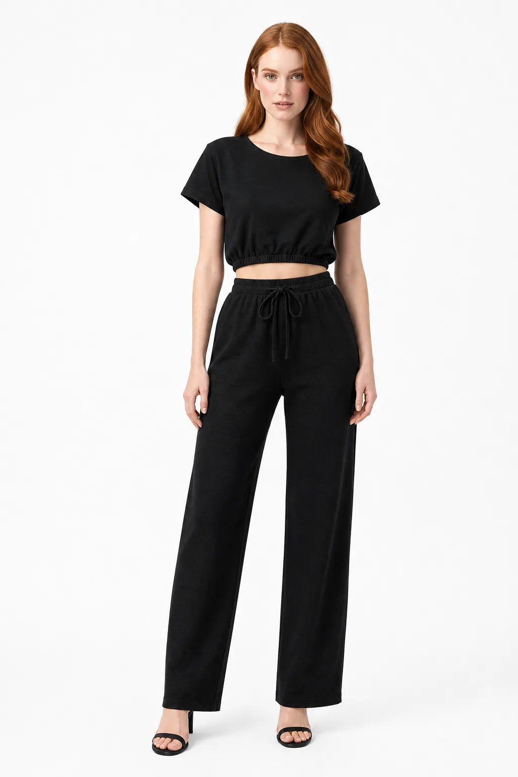 Black crop top and wide-leg trouser co-ord set on model in contrapposto stance