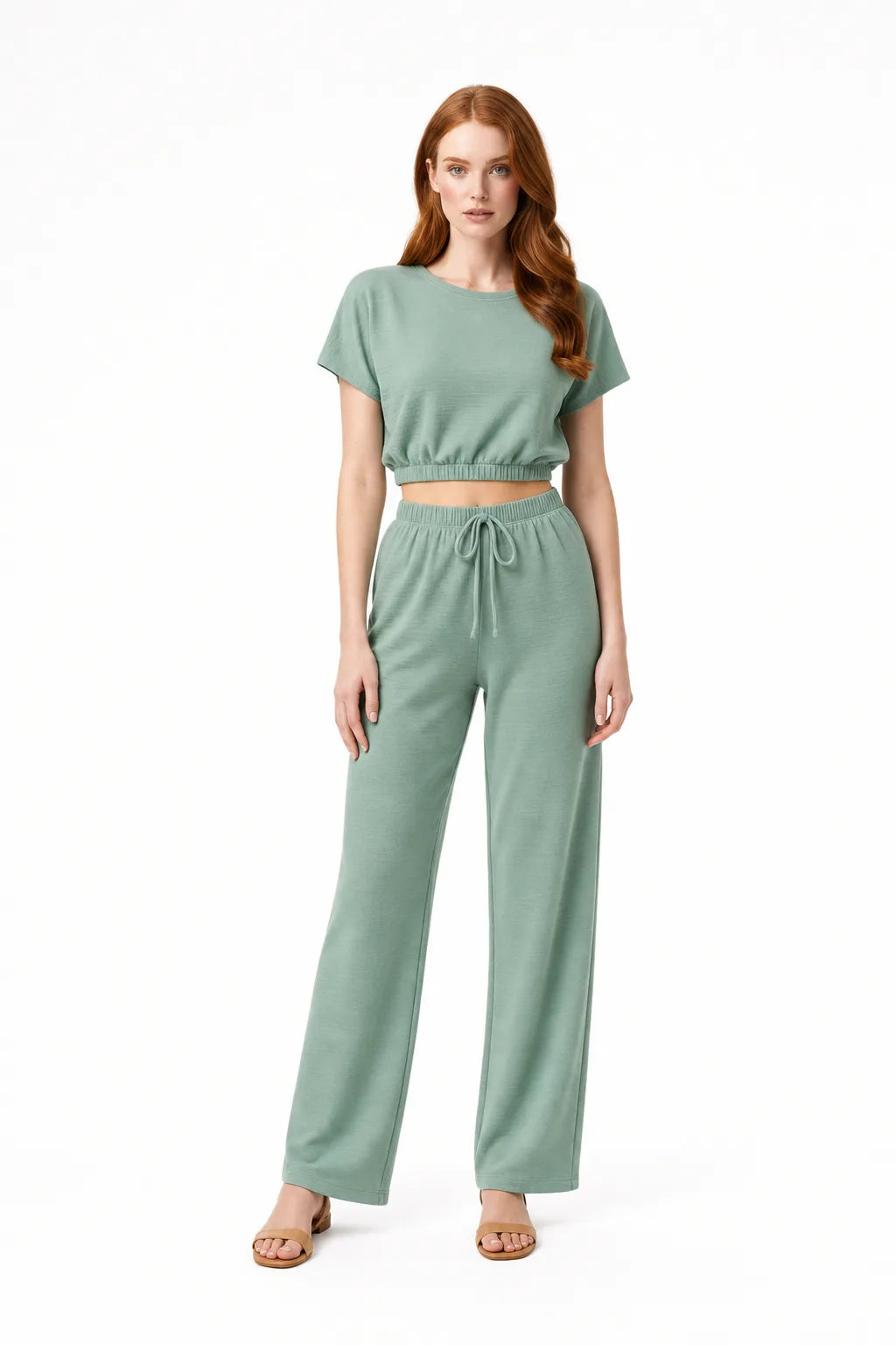 Lime green crop top and wide-leg trouser co-ord set on model in contrapposto stance