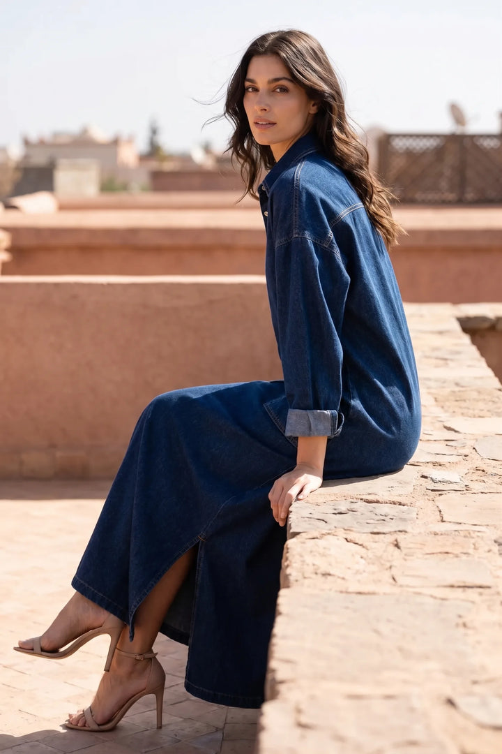 Model styled in blue denim maxi dress in relaxed lifestyle setting