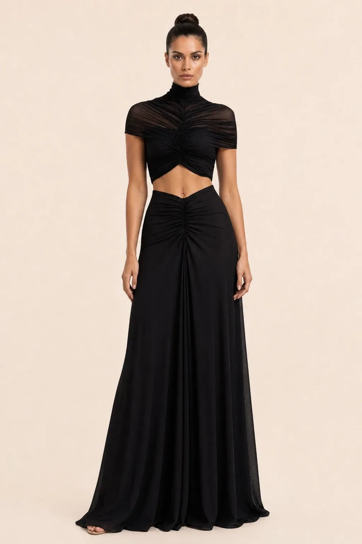 Black ruched cut-out maxi dress on model in contrapposto stance