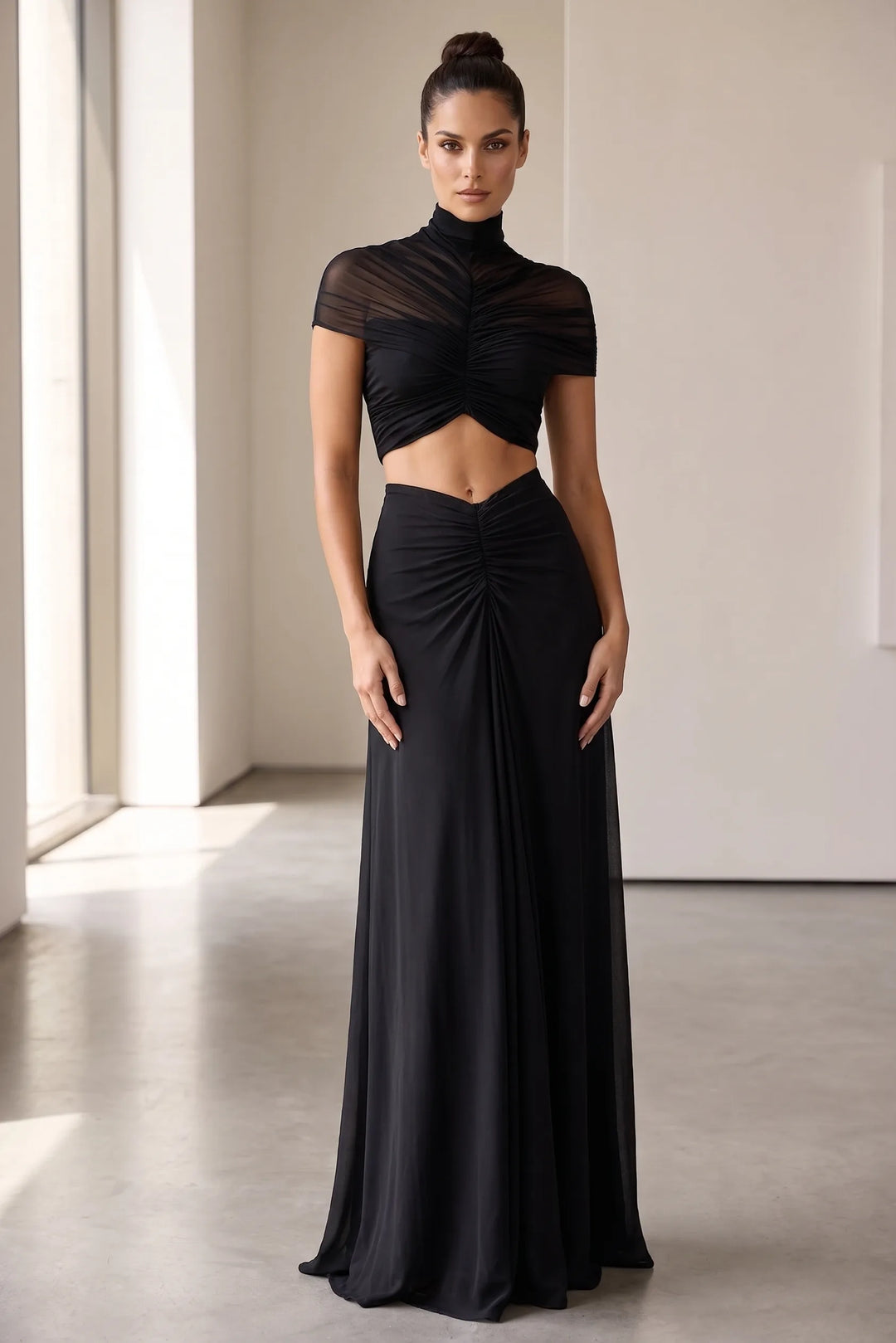 Model wearing black ruched cut-out maxi dress in lifestyle setting