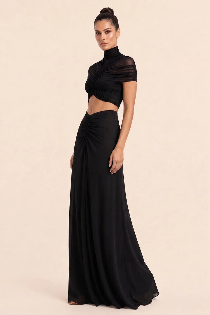 Black ruched cut-out maxi dress on model in three-quarter turn