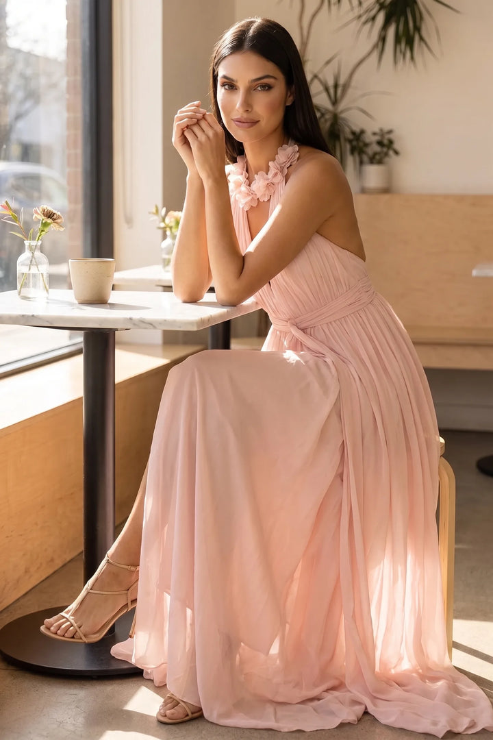 Model in pink floral halter maxi dress posed in second lifestyle scene