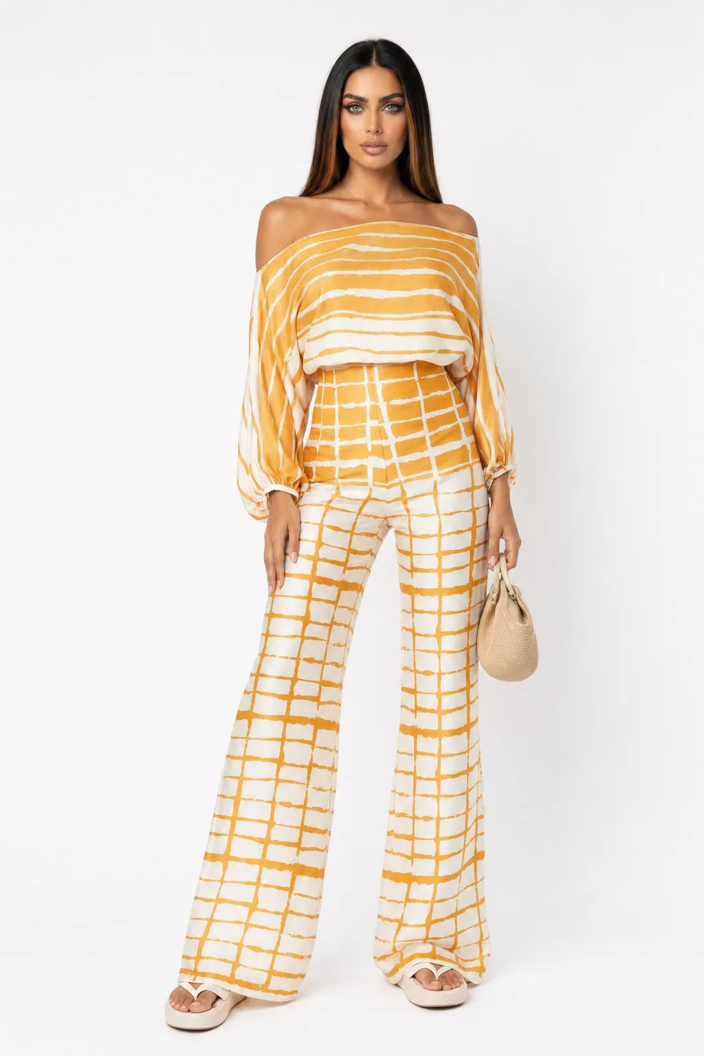 Yellow abstract print matching trouser set on model in contrapposto stance