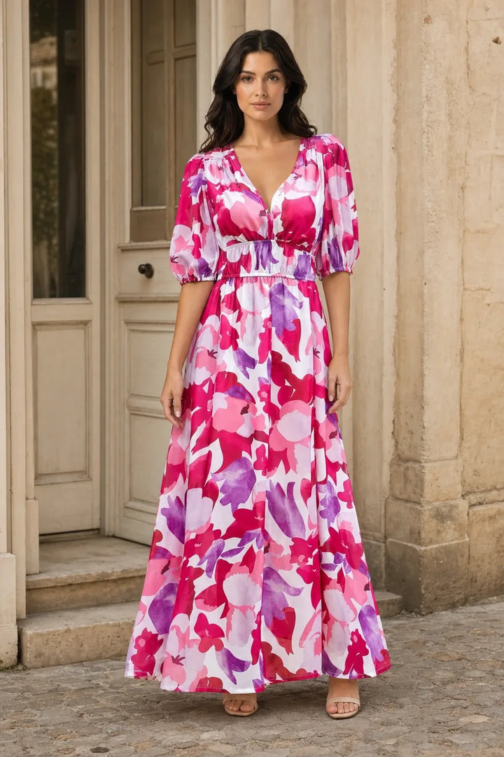 Pink floral chiffon midi dress on a model in a contrapposto stance