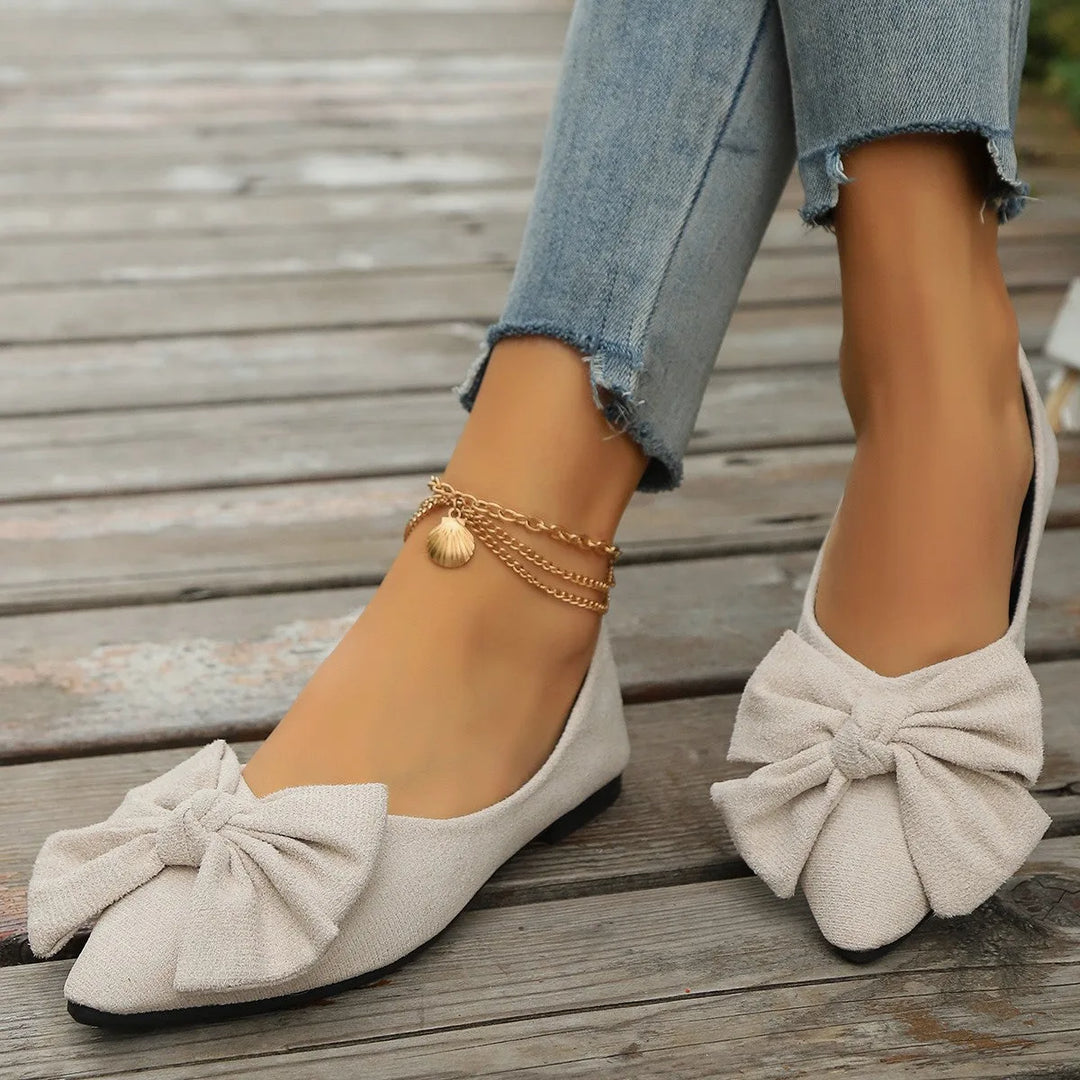 Beige ballet flat with bow detail, heel view