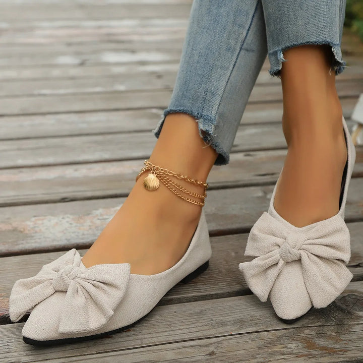 Beige ballet flat with bow detail, heel view