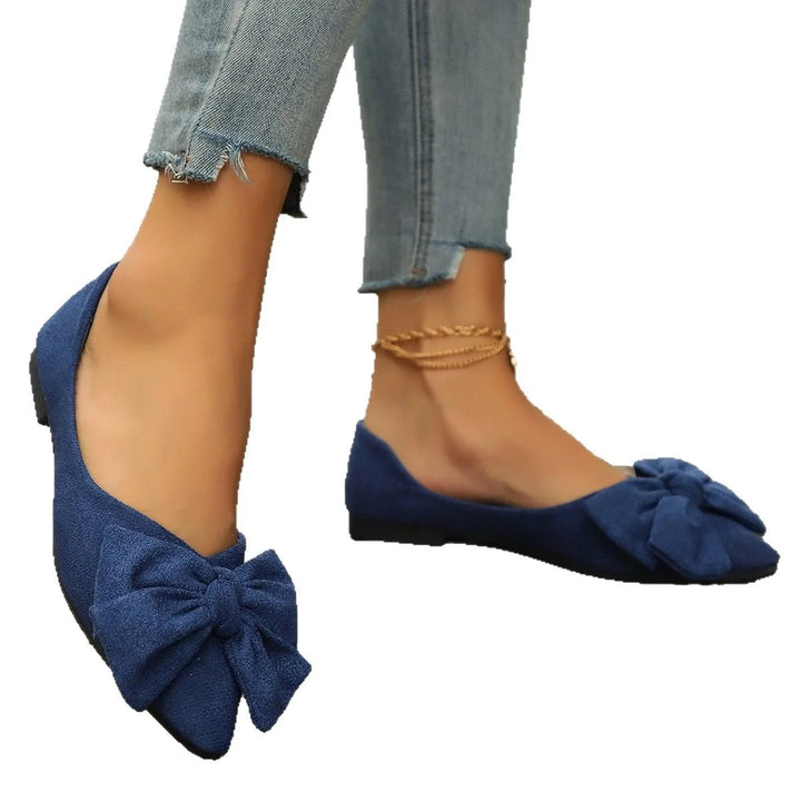 Black ballet flat with bow detail, close-up detail view