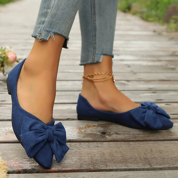 Dark blue ballet flat with bow detail, alternate angle view