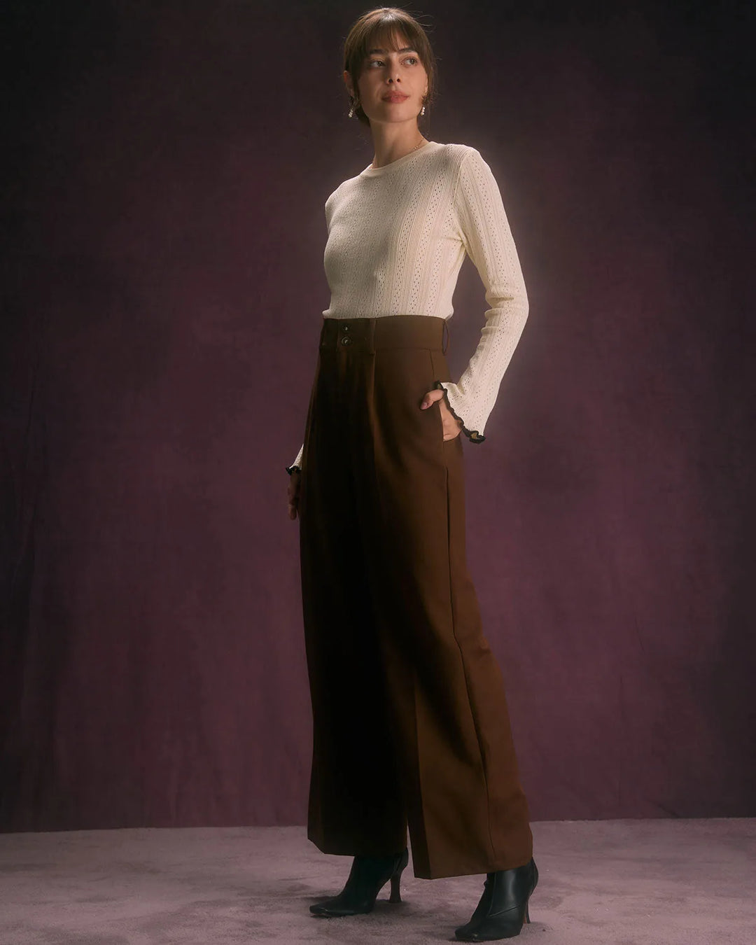 Model styled in wide-leg coffee brown trousers in a relaxed standing pose