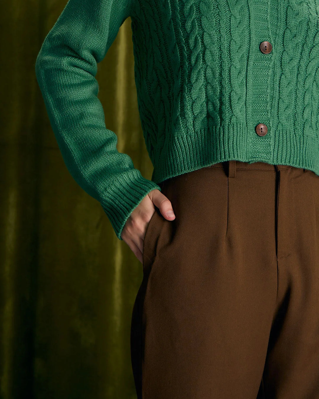 Model wearing wide-leg coffee brown trousers shown from a complementary angle
