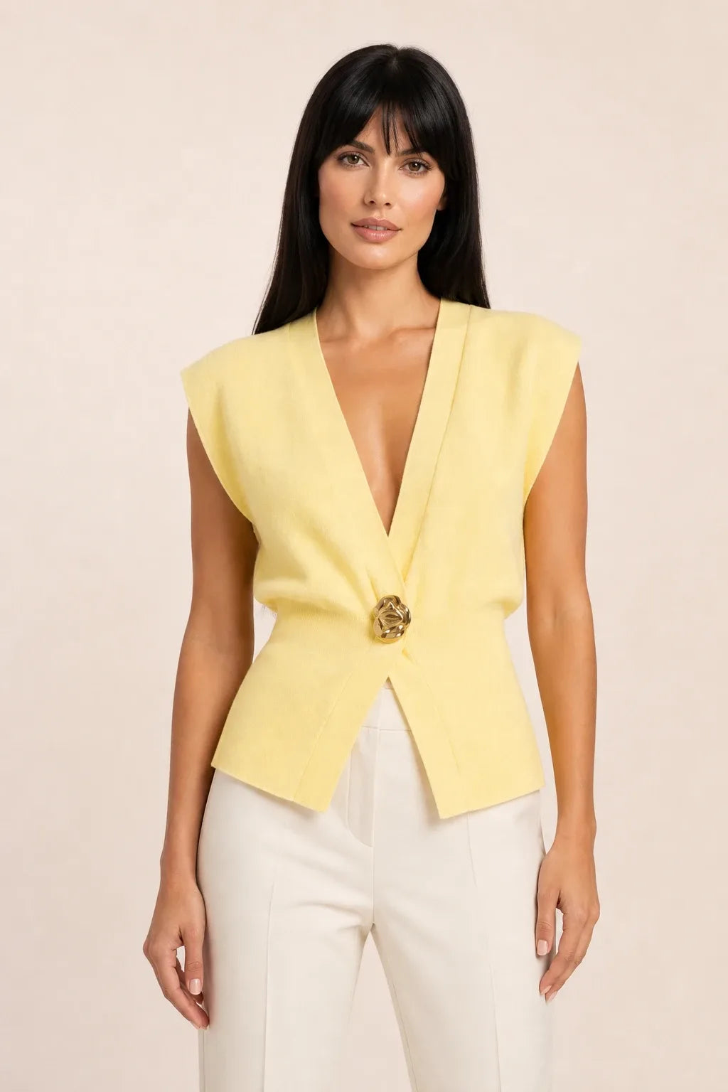 Yellow button-front vest top on model in contrapposto stance