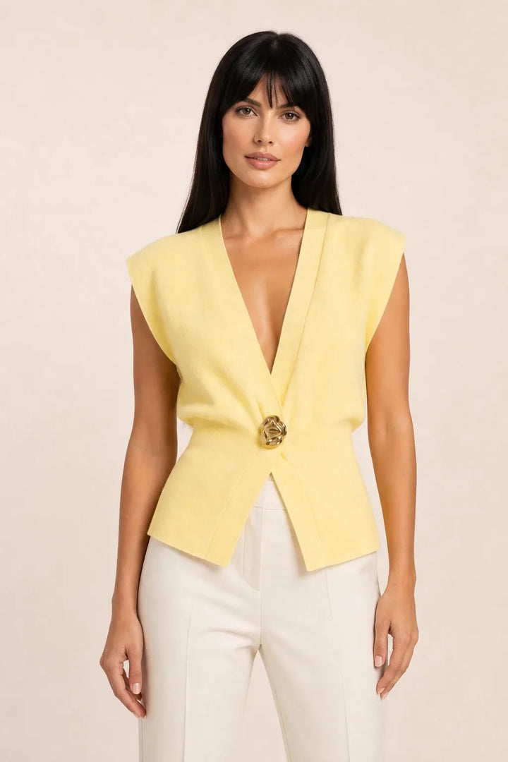 Yellow button-front vest top on model in contrapposto stance
