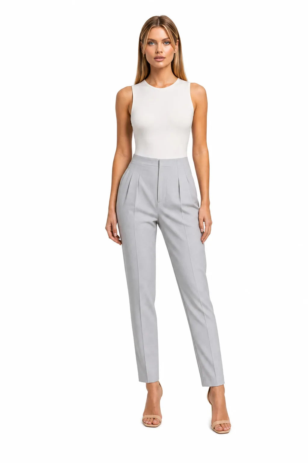 Grey pleated tapered trousers on a model in a contrapposto stance