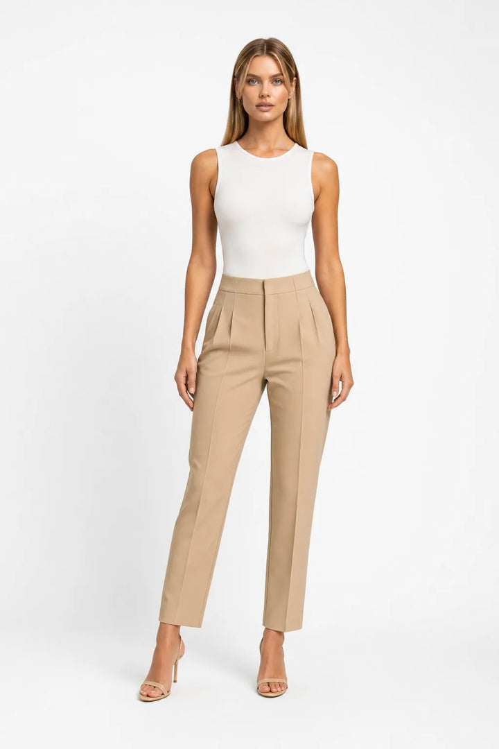 Khaki pleated tapered trousers on a model in a contrapposto stance