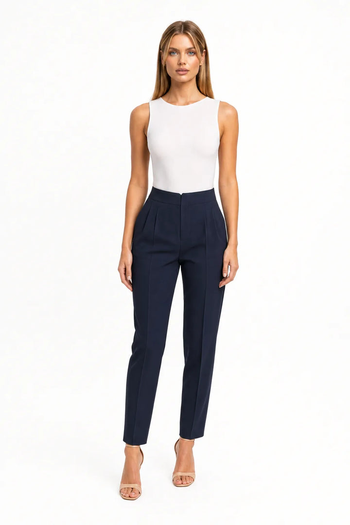 Royal blue pleated tapered trousers on a model in a contrapposto stance