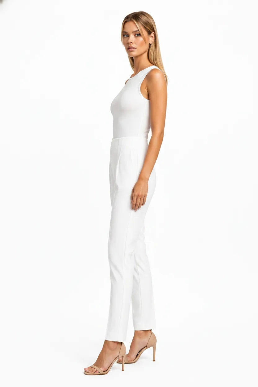 White pleated tapered trousers on a model in a three-quarter turn