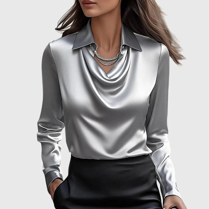 Silver satin cowl neck blouse on model in three-quarter turn