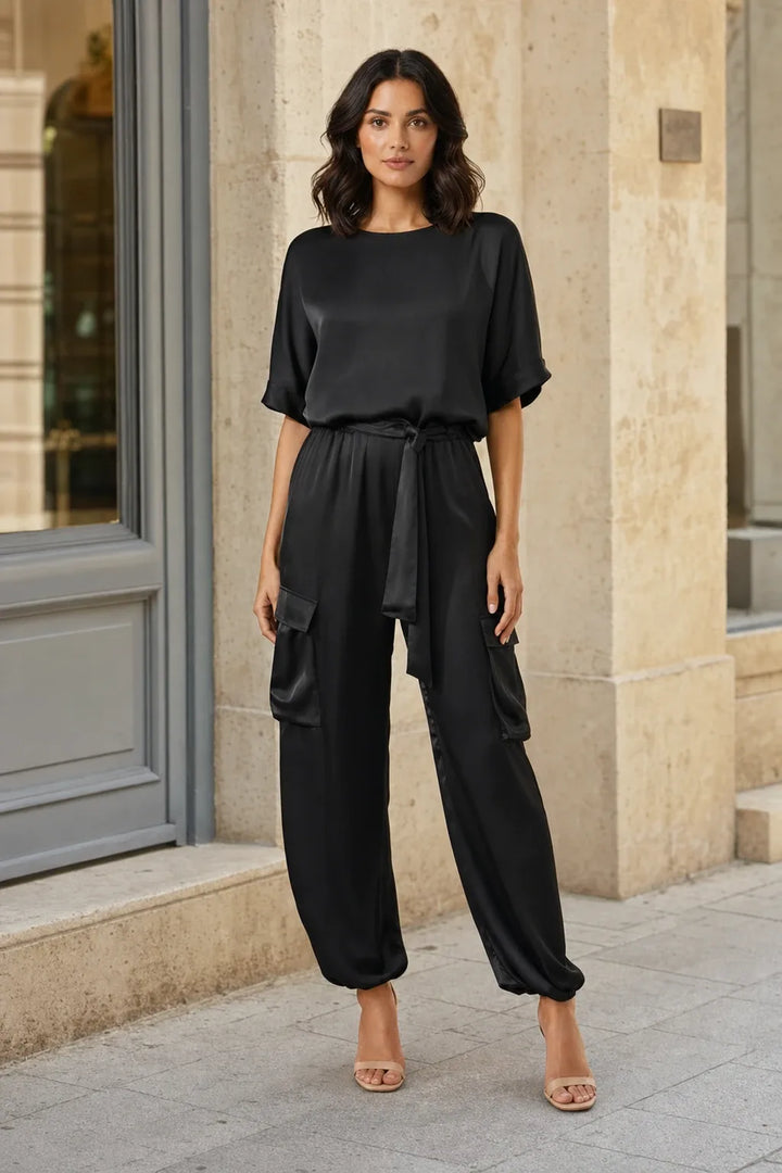 Black satin cargo co-ord set on model in contrapposto stance