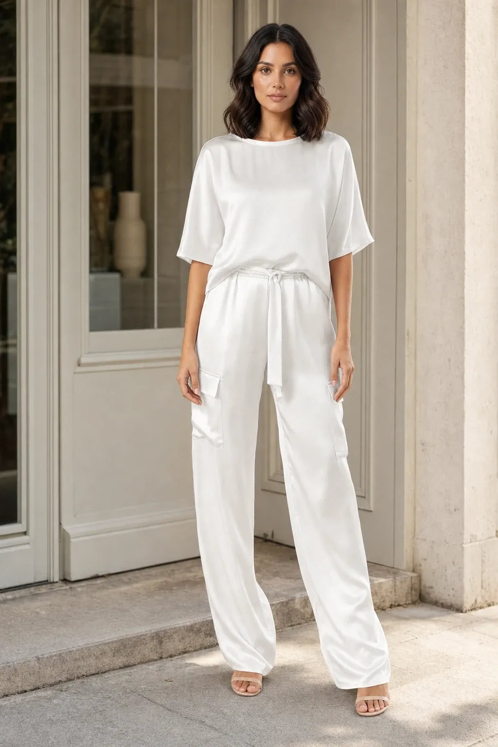 White satin cargo co-ord set on model in contrapposto stance