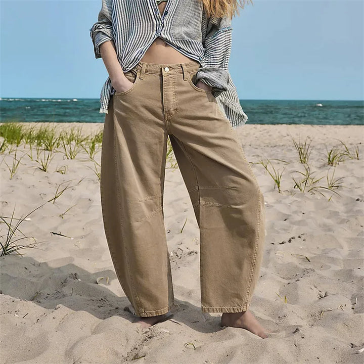 Beige barrel leg jeans on model, full-length view showing relaxed tapered fit