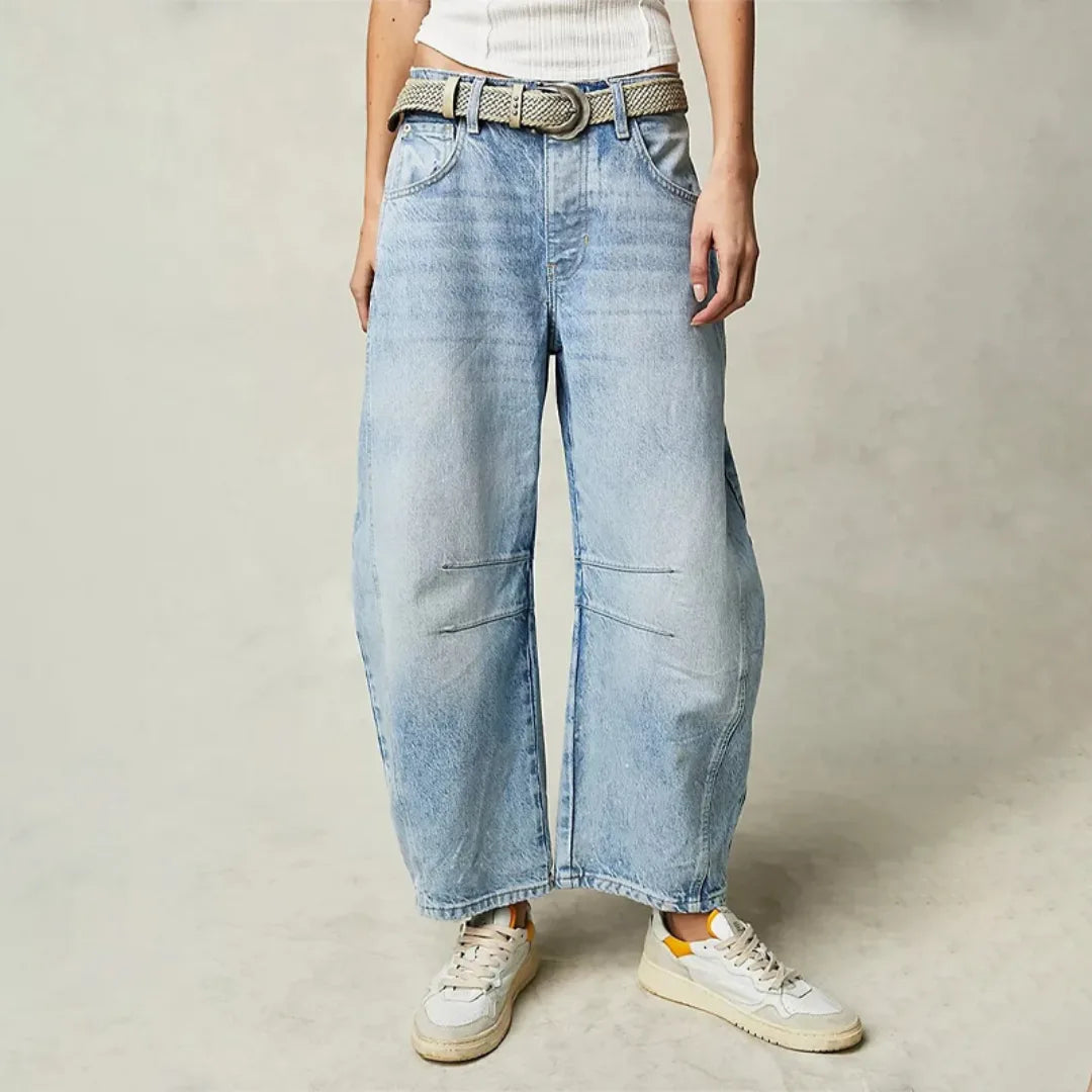 Light blue barrel leg jeans on model, front view showing relaxed tapered fit