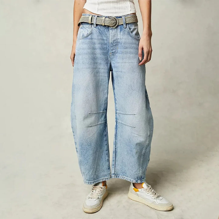 Light blue barrel leg jeans on model, front view showing relaxed tapered fit