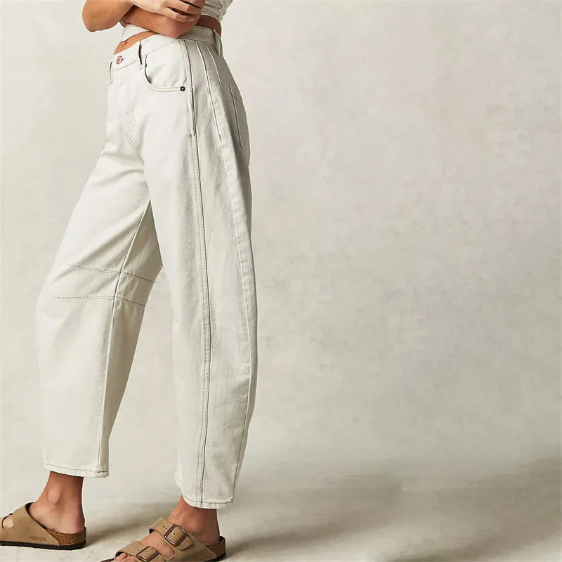 Light blue barrel leg jeans on model, full-length view from slight angle