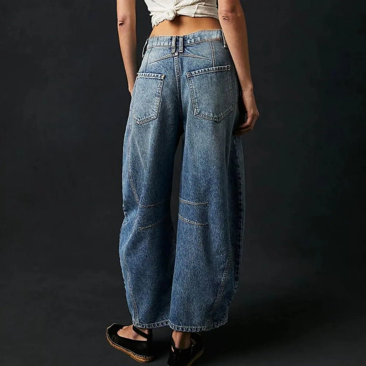 Light blue barrel leg jeans on model, full-length view highlighting fit