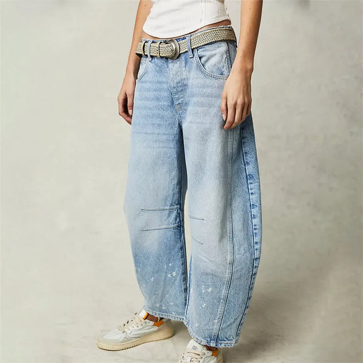 Light blue barrel leg jeans on model, full-length view showing tapered hem