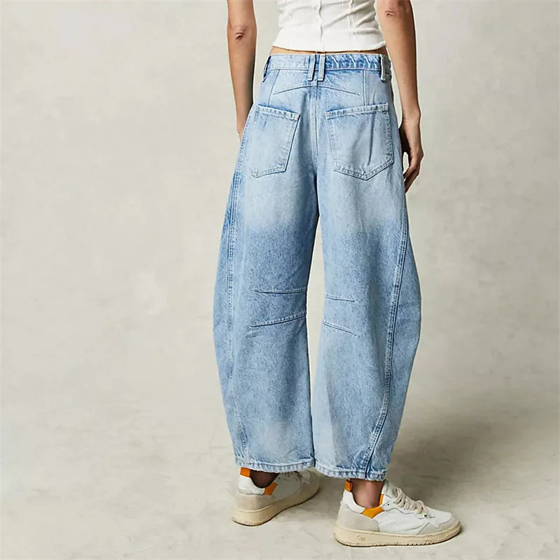 Light blue barrel leg jeans on model, full-length alternate angle view
