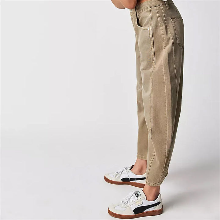 Light blue barrel leg jeans on model, full-length view showing relaxed fit
