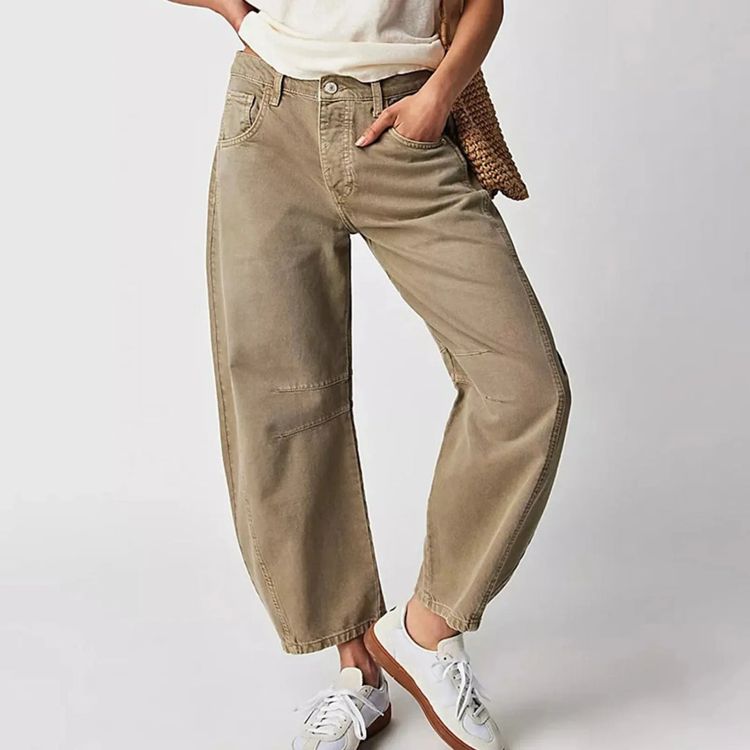 Light blue barrel leg jeans on model, full-length view with subtle angle