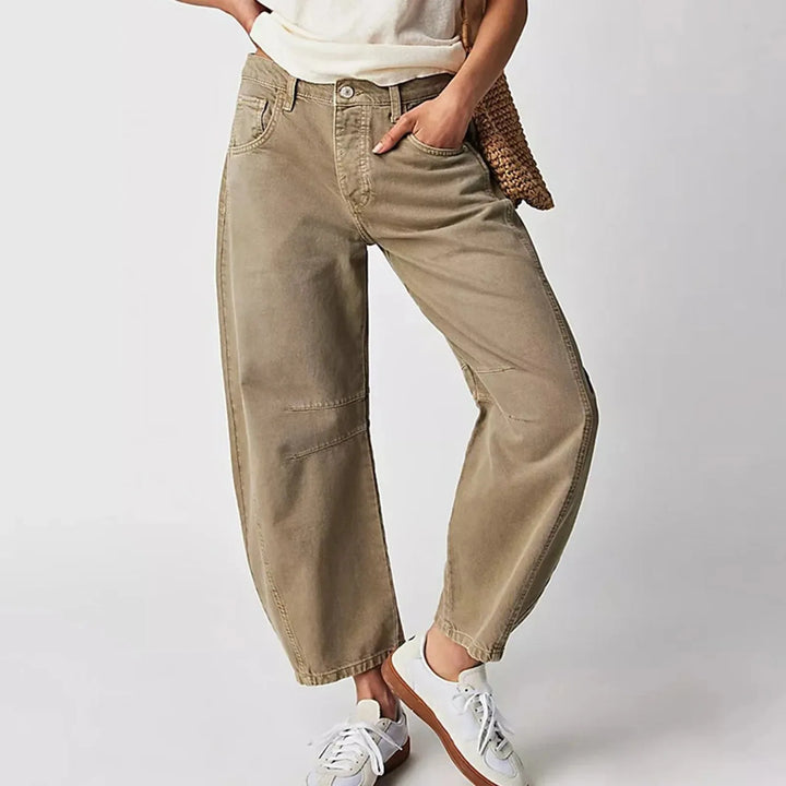 Light blue barrel leg jeans on model, full-length view with subtle angle
