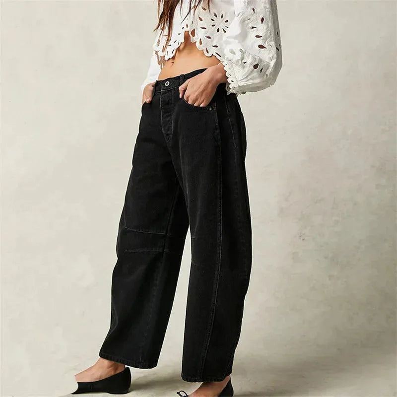 Light blue barrel leg jeans on model, full-length view highlighting silhouette