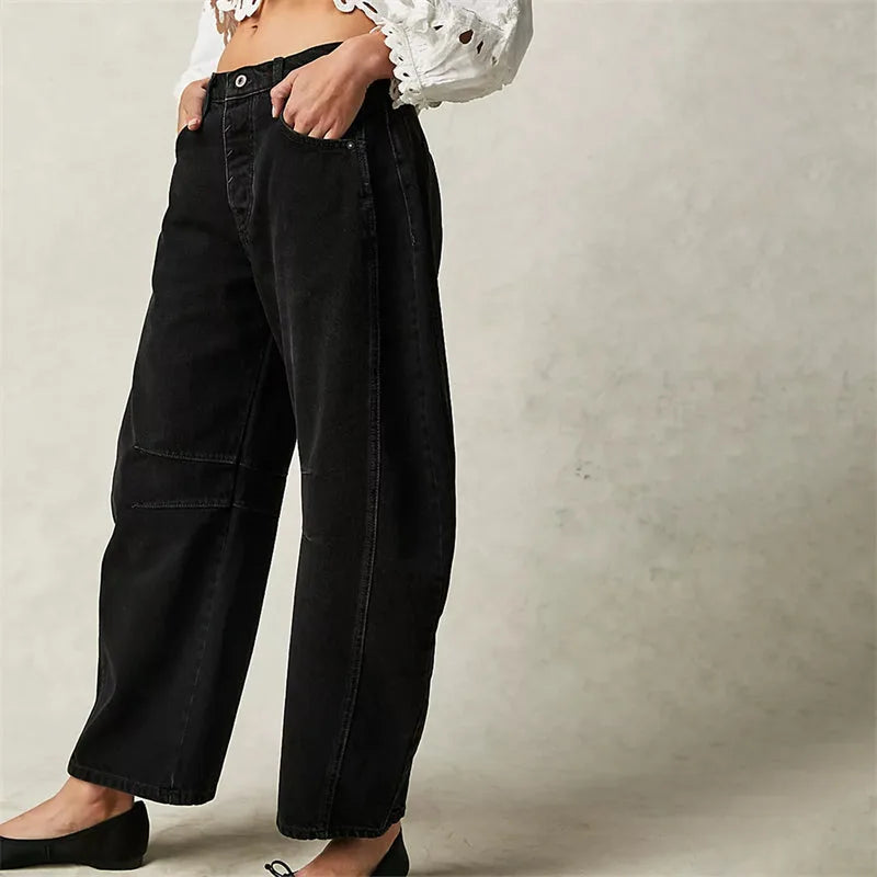 Light blue barrel leg jeans on model, full-length front view with cropped hem