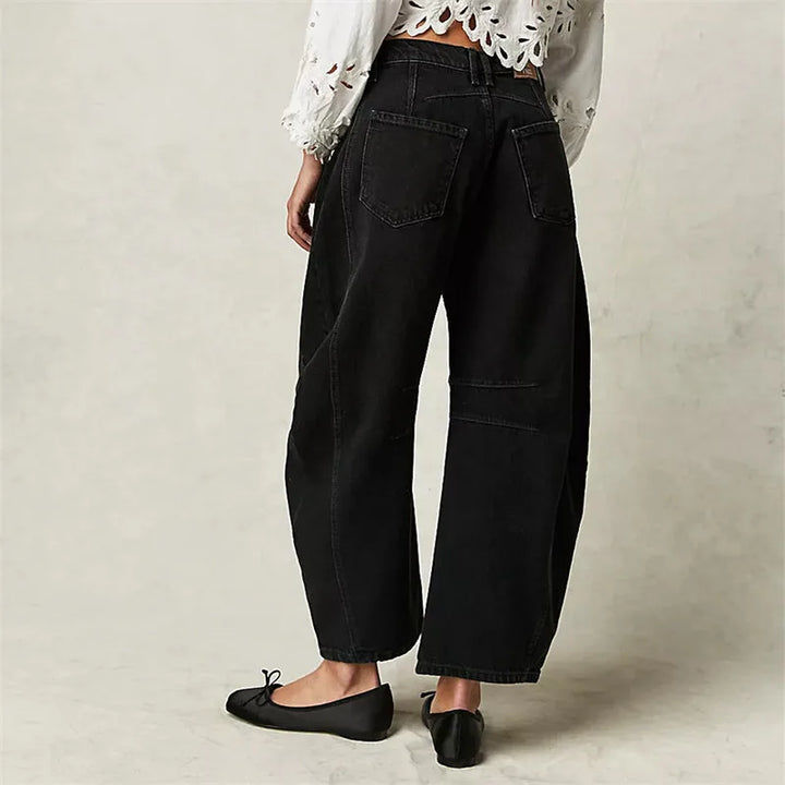 Light blue barrel leg jeans on model, full-length view showing barrel leg detail